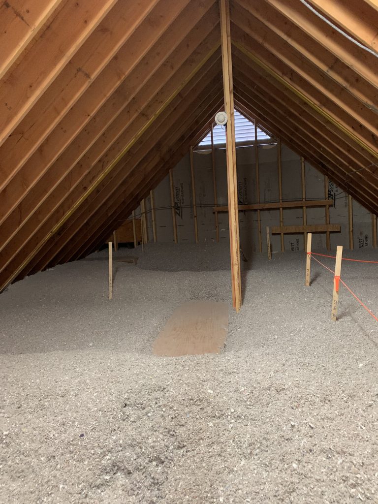 Loose-fill cellulose insulation in the attic of Cold Brook Farm, NJ
